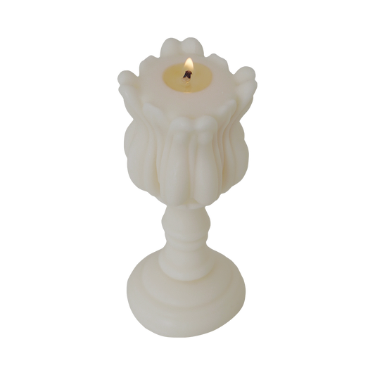 a lit tulip shape candle
