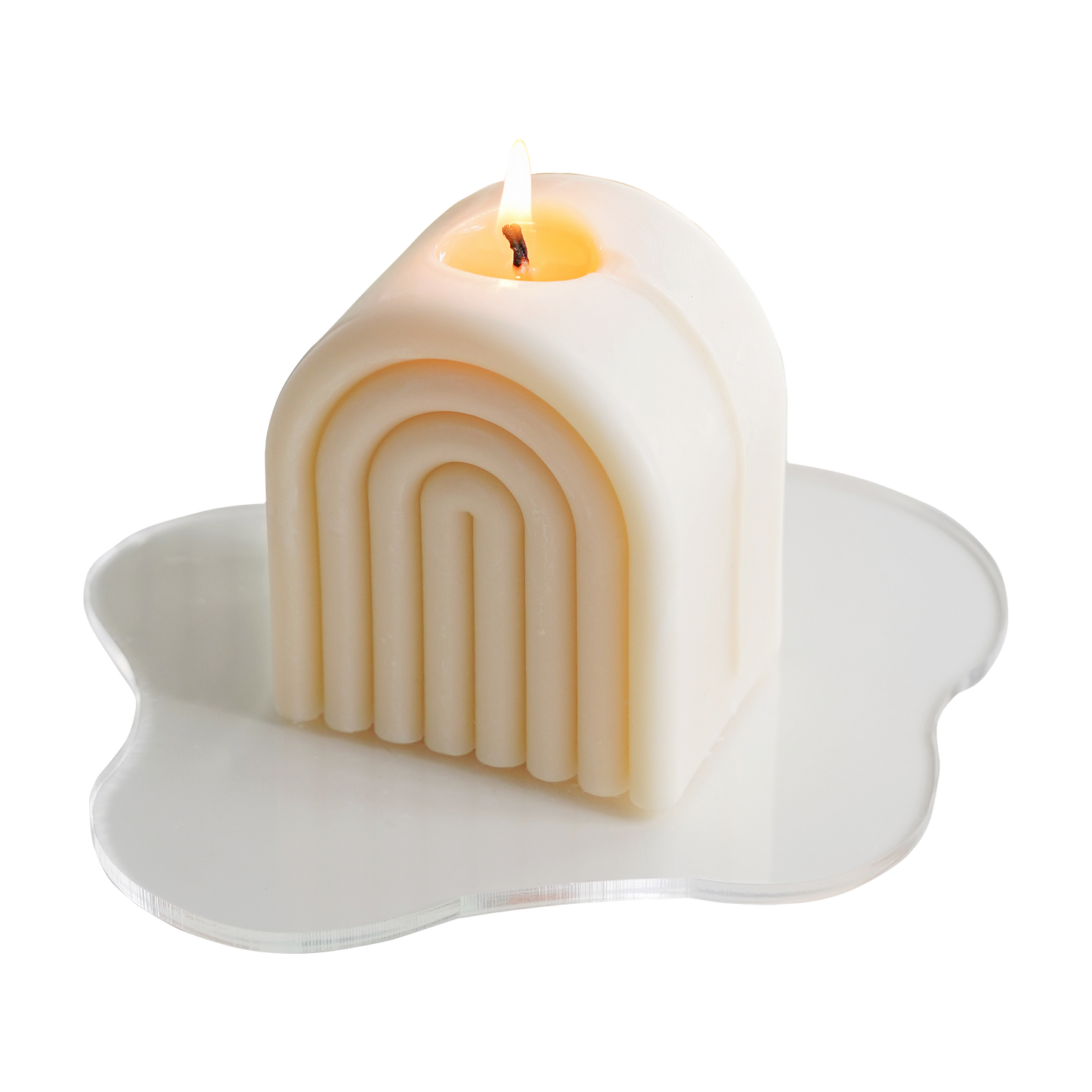 a lit white rainbow soy pillar candle on a clear wavy acrylic coaster