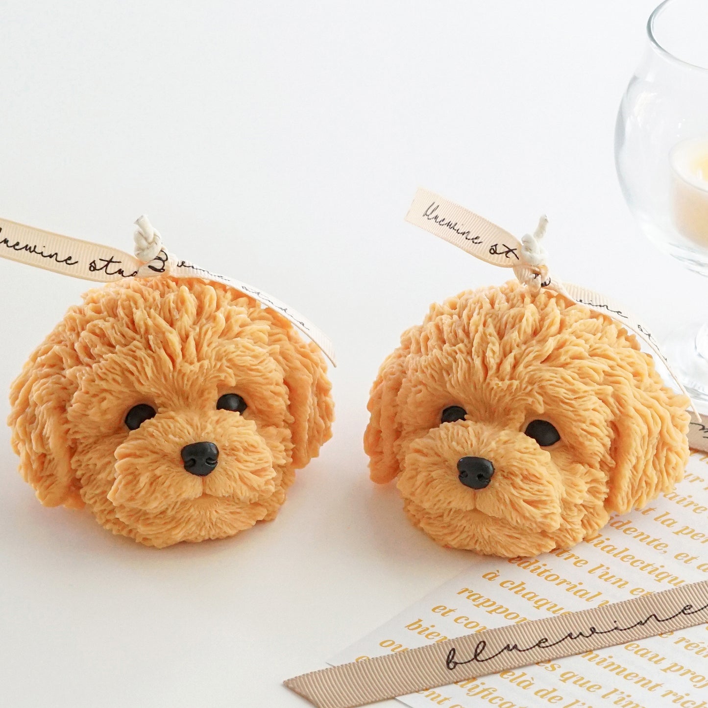 two goldendoodle dog soy candles with bluewine ribbons and tealight candle in a glass