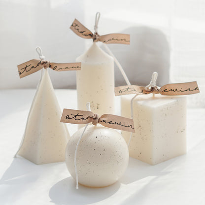 dotted white soy pillar candle collection: sphere, cylinder, pentagonal pyramid, square pillar shape