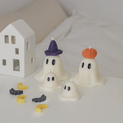 wizard and pumpkin ghost candles with mini ghost candles on white table for halloween room decor