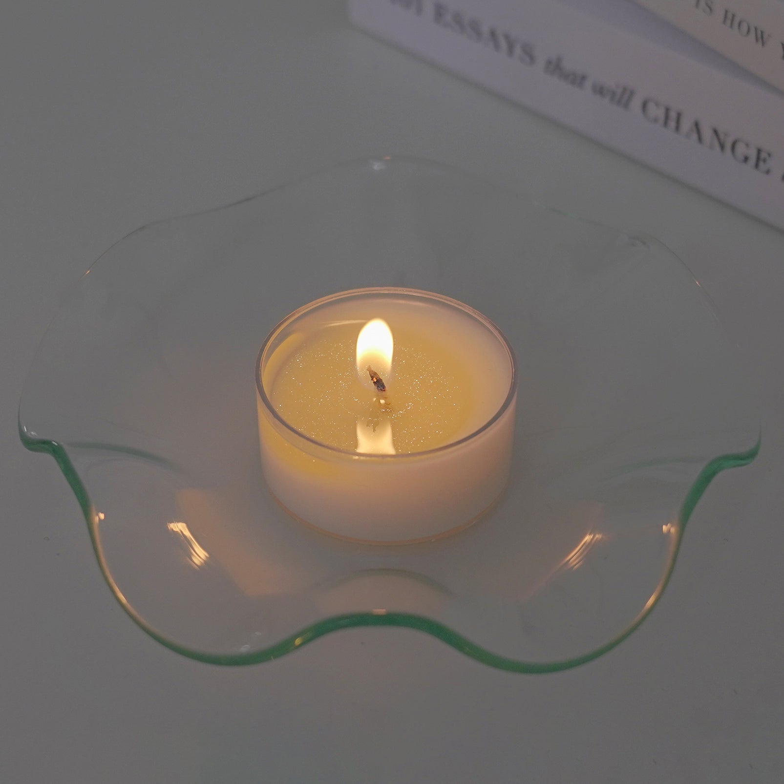 glistening tealight candle with glitter soy wax on a clear ruffle dish