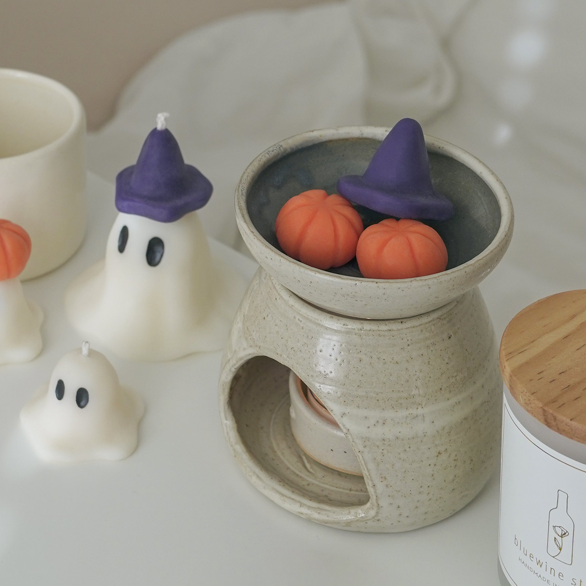 purple wizard hat and pumpkin wax melts in a wax warmer