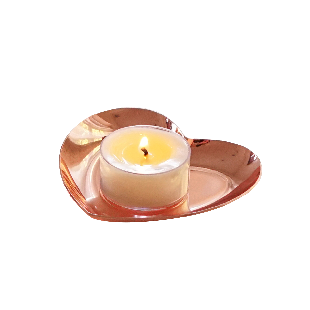 a lit tealight candle on a rose gold heart tray