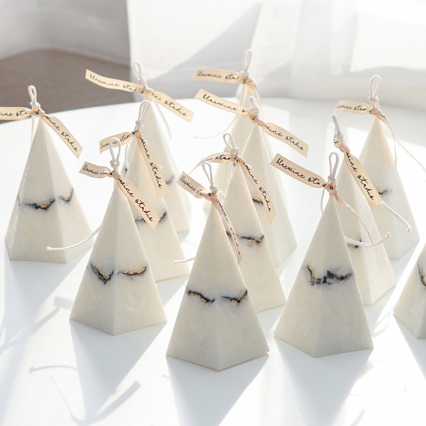 bulk orders of pentagonal pyramid shape marble candles with light beige bluewine studio ribbons