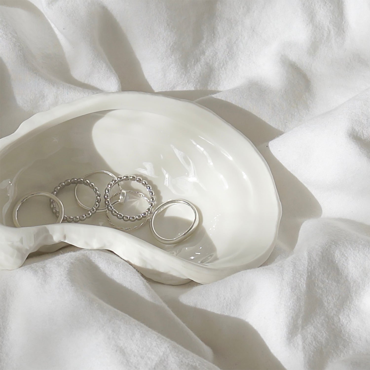 silver rings in a oyster shaped jewelry, trinket dish for perfect beach house aesthetic decor