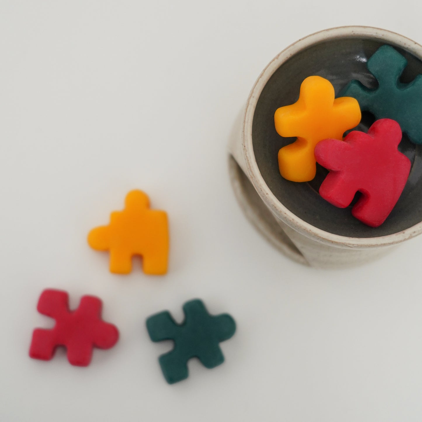 red, yellow, and green puzzle shape wax melts in a wax warmer
