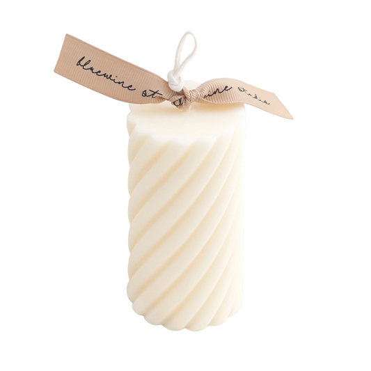 white spiral soy pillar candle with beige ribbon