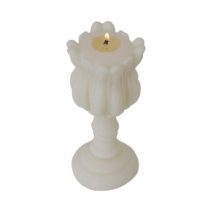 a lit tulip shape candle